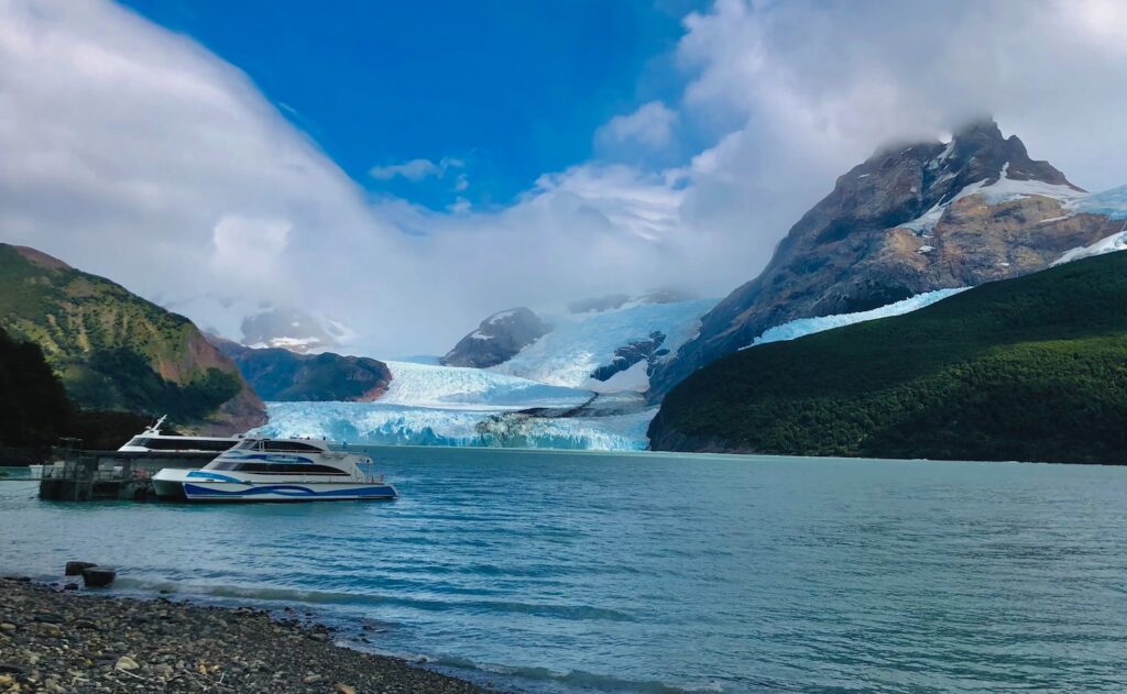 a boat in a body of water near a glacier