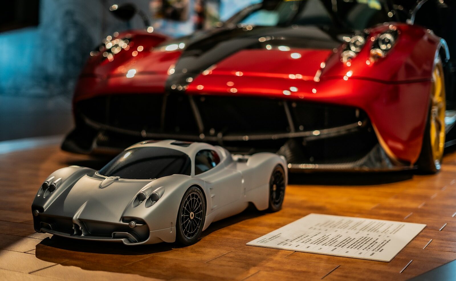 A red sports car and a silver sports car on display