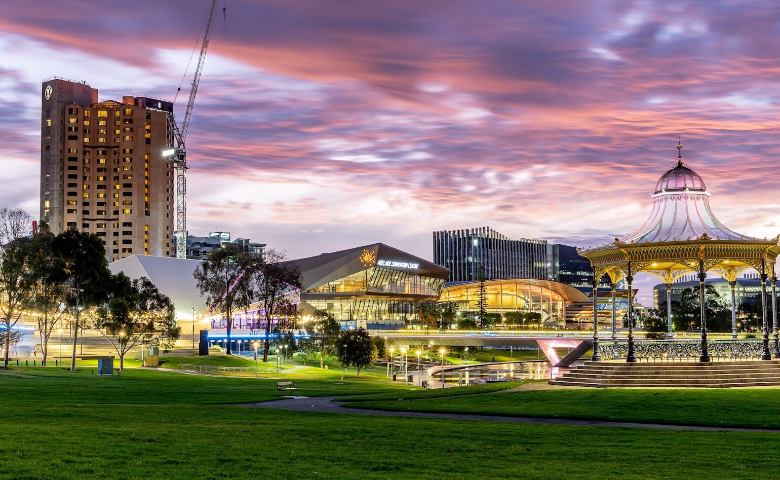 a park with a carousel and buildings in the background